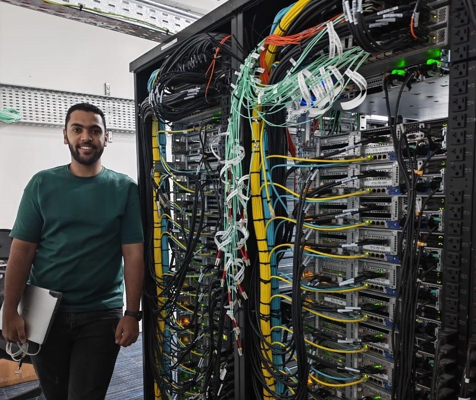 A Stark Technology engineer beside a rack his team cabled and now runs
