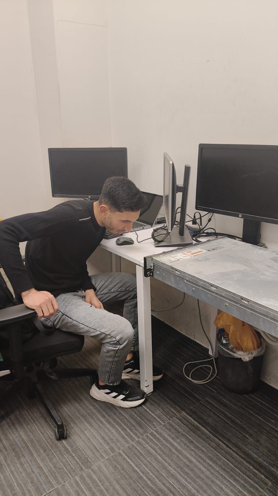 A Stark Technology engineer working at a dual-monitor workstation